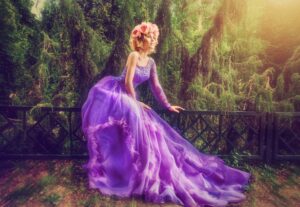 There is a picture of girl wearing a purple gown, sitting on a branch that shows she is living a perfect world. 