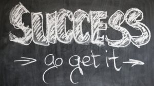 There is a picture of a blackboard with written, "Success, go get it" and further leads to the question that does intellgnce guarantee success?  