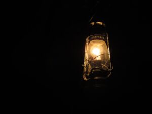 This is an image of a lightning lamp in total darkness which highlights the theme of loneliness in the Verity Quotes.