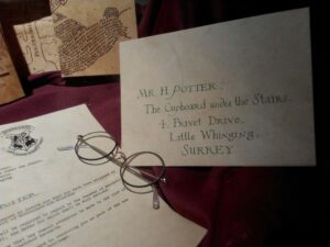 There is is a picture of a letter and glasses and is showing one of the movies based on books. 