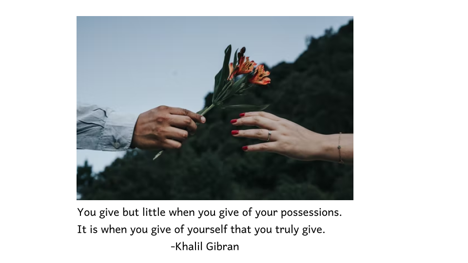 This is an image of a man giving flowers to a woman, showing one of the best Khalil Gibran quotes.